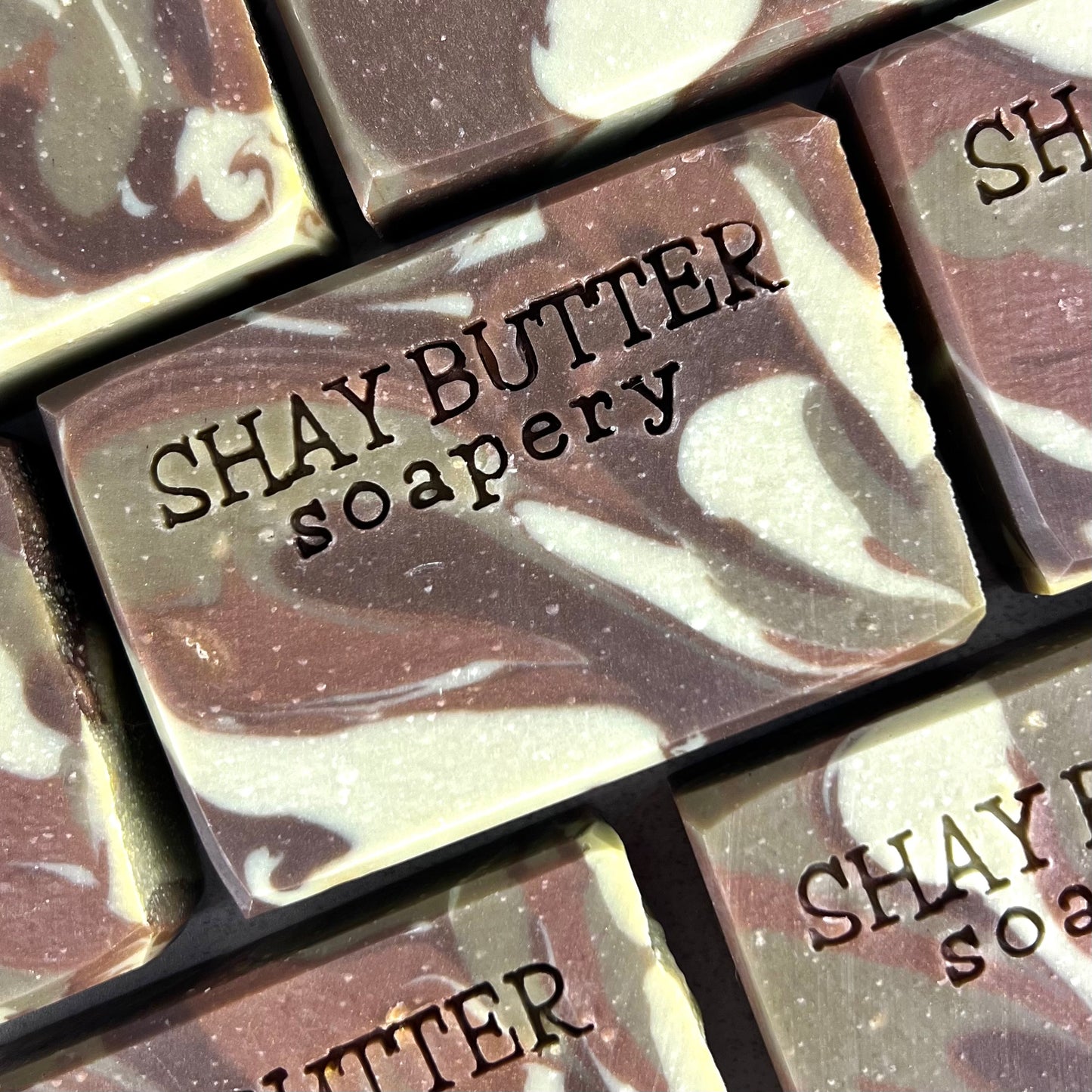 Close-up of Shay Butter Soapery soap bars with marbled design