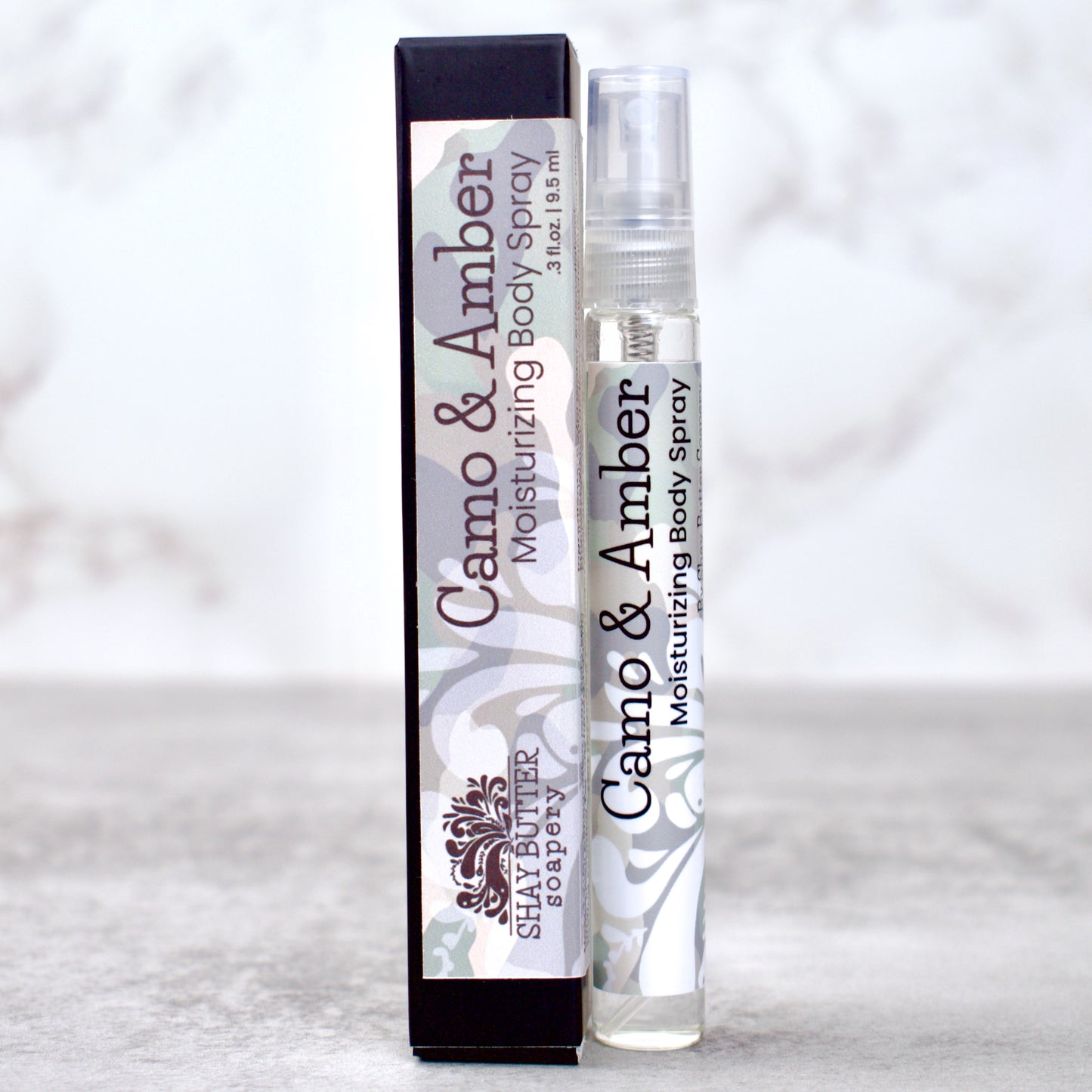 Camo & Amber moisturizing body spray with packaging on a light gray background