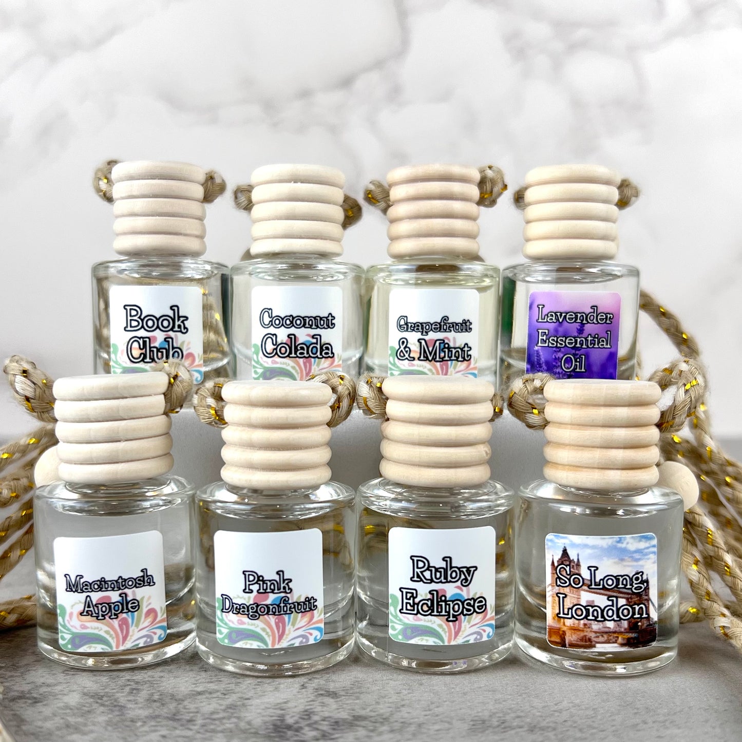 A group of hanging car diffusers of various scents.