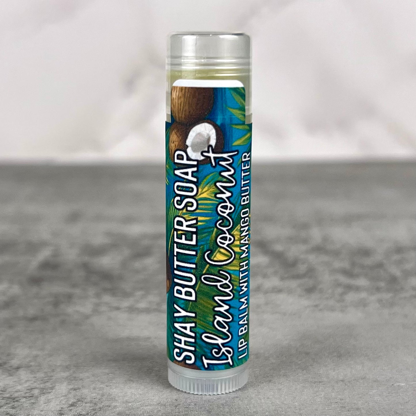 Lip balm with coconut flavor packaging on a gray background