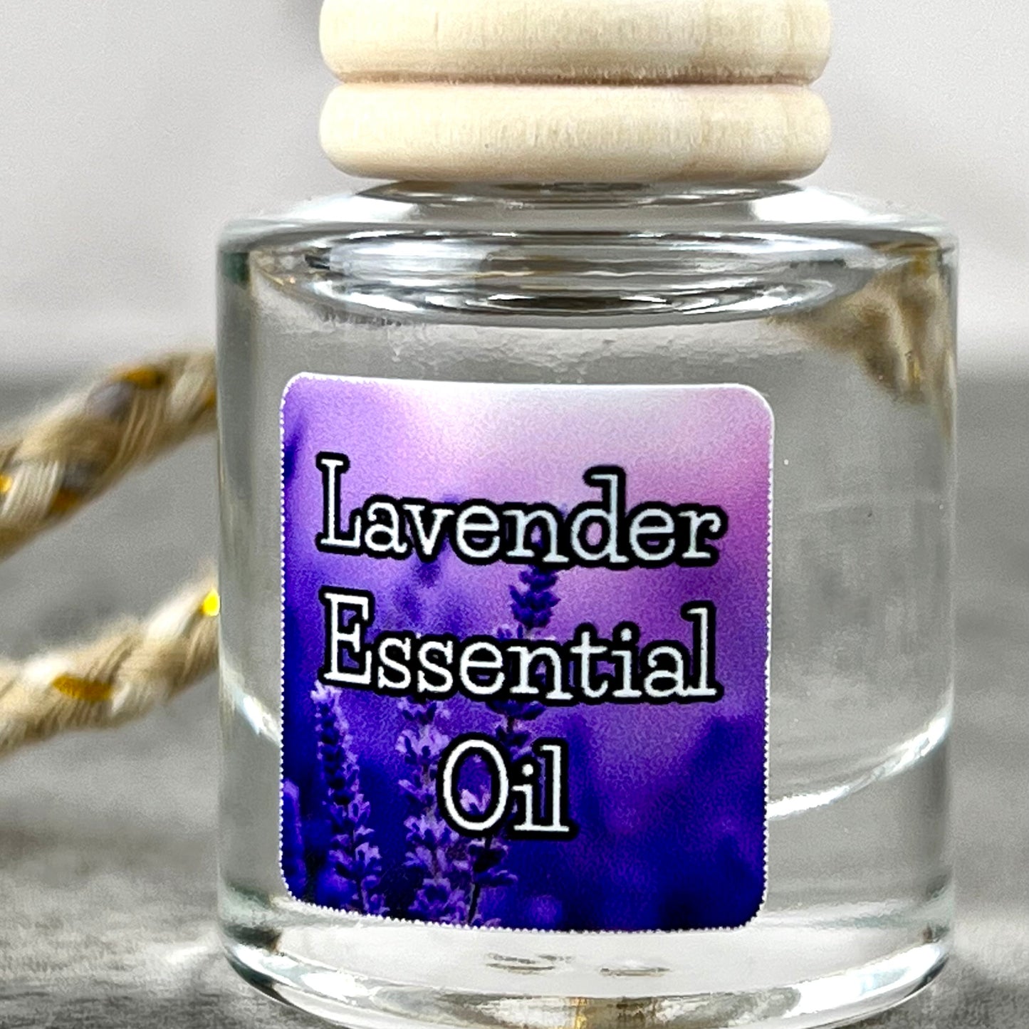 Lavender essential oil car diffuser with purple label on grey background