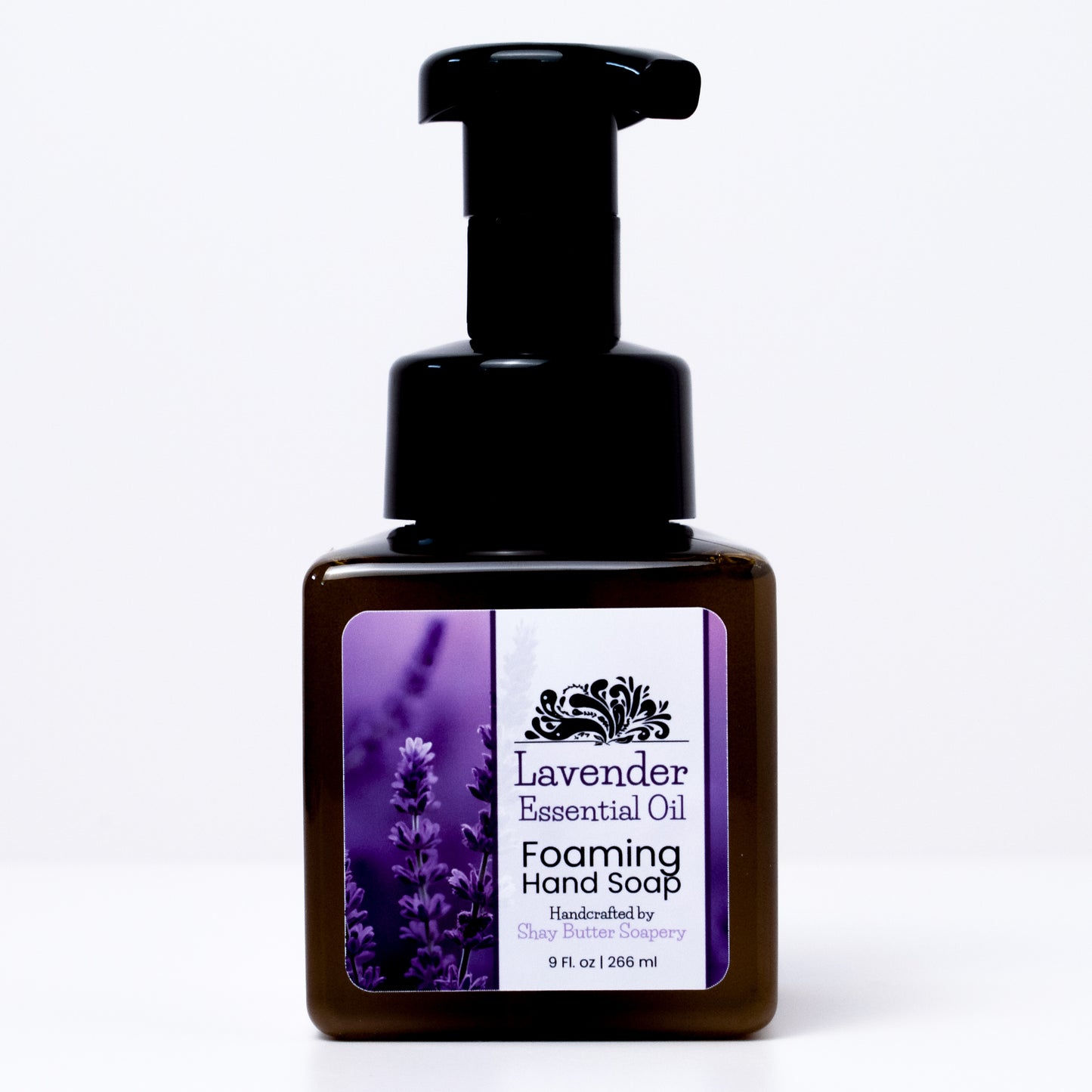 a bottle of "lavender essential oil" foaming hand soap on a white background
