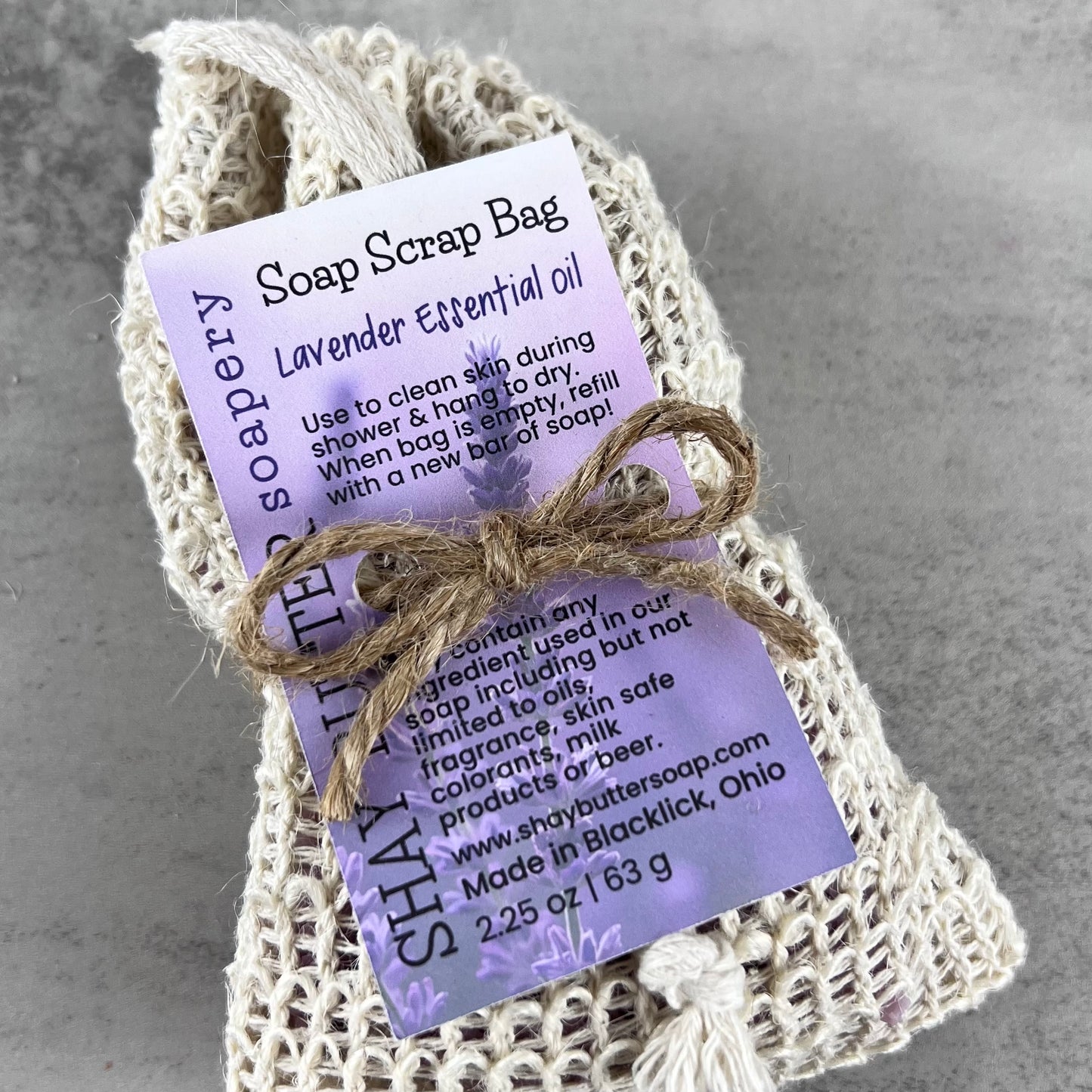 Lavender essential oil soap scrap bag with label on a gray background