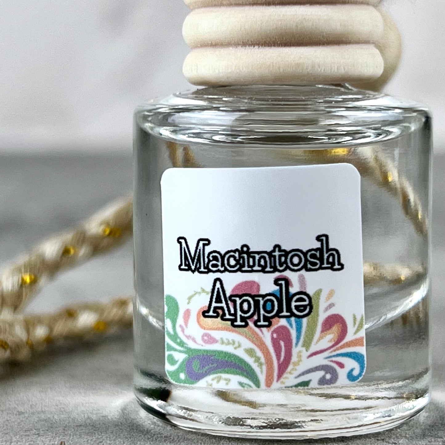 Car diffuser with a 'Macintosh Apple' label on a neutral background