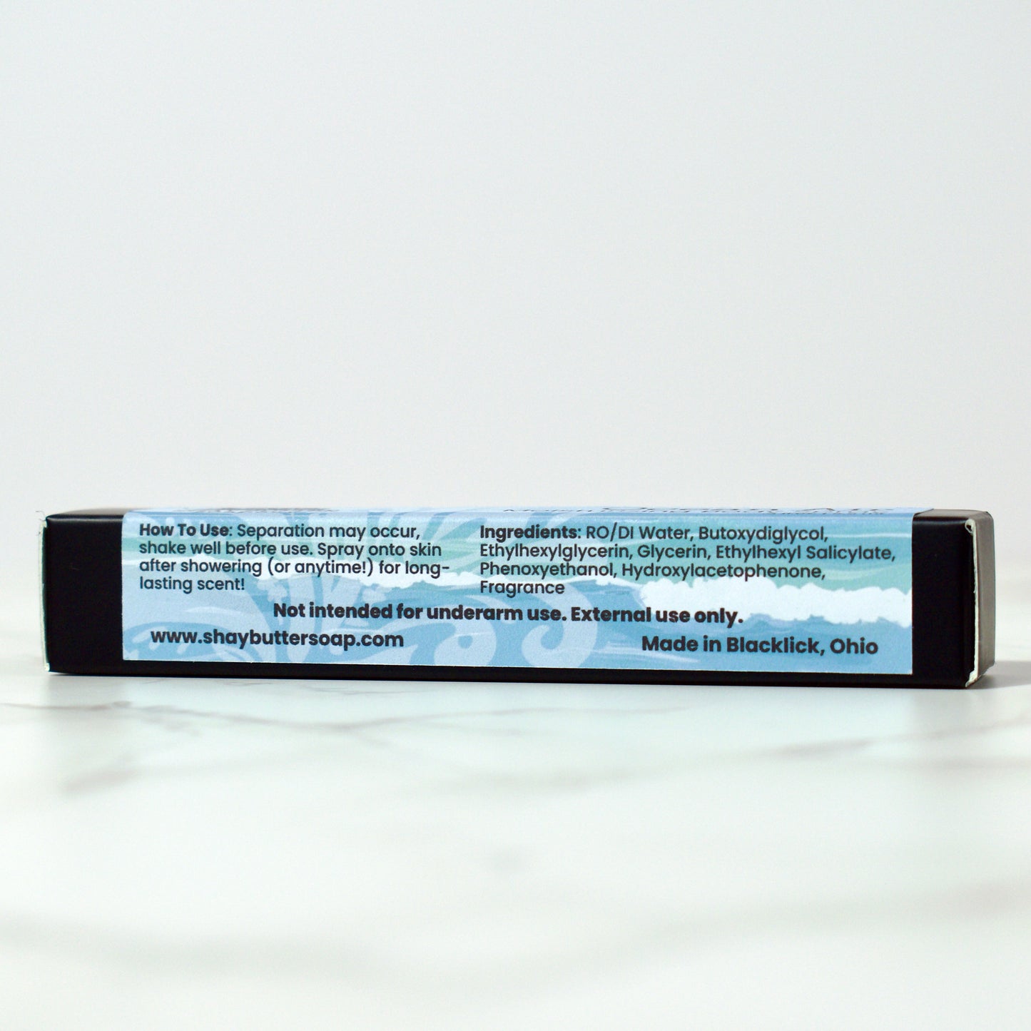 Body spray packaging with text on a white background