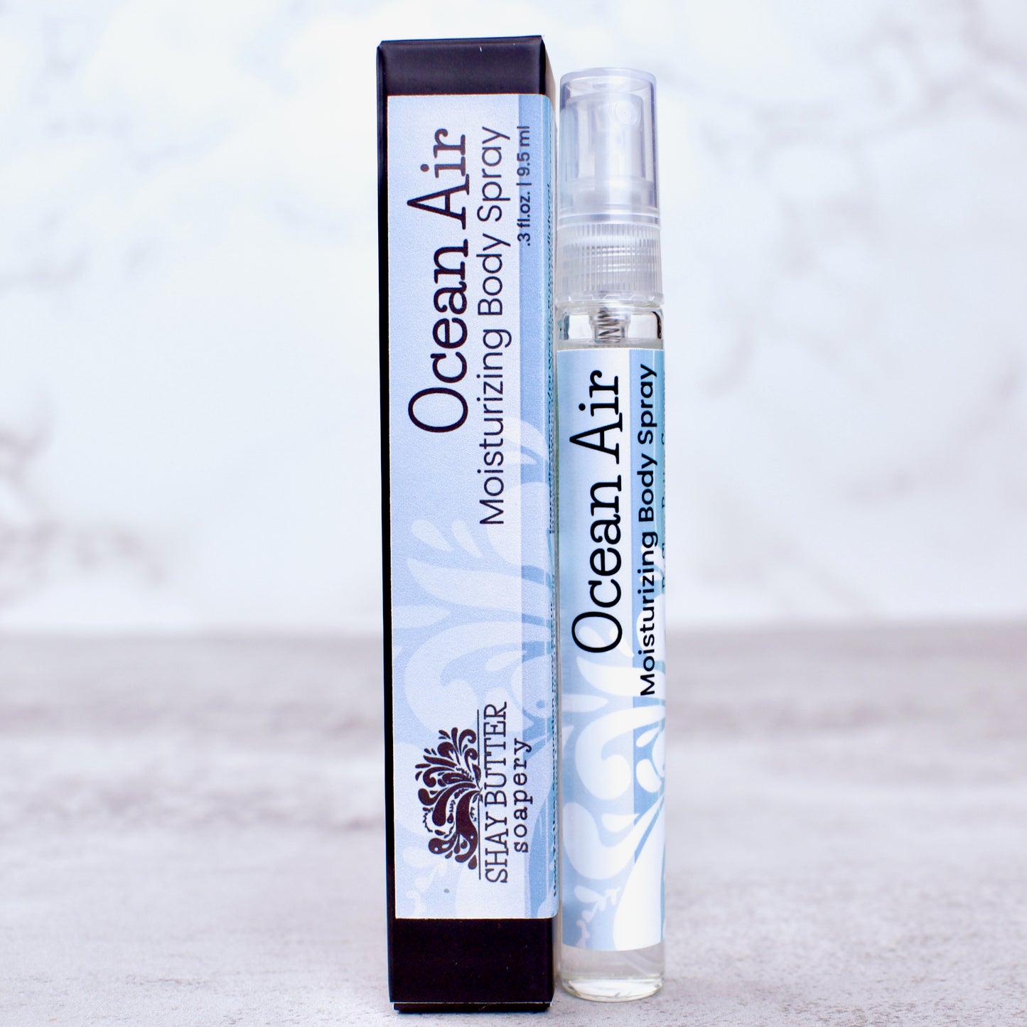Ocean Air moisturizing body spray with packaging on a light gray background