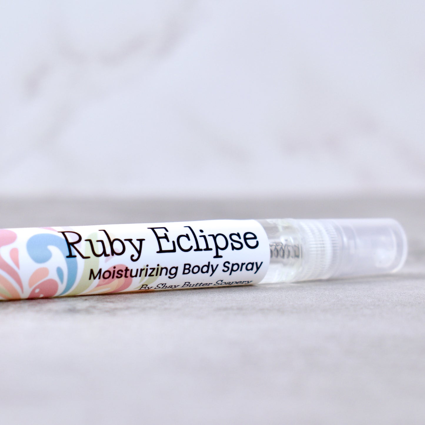 Ruby Eclipse moisturizing body spray on a light gray background