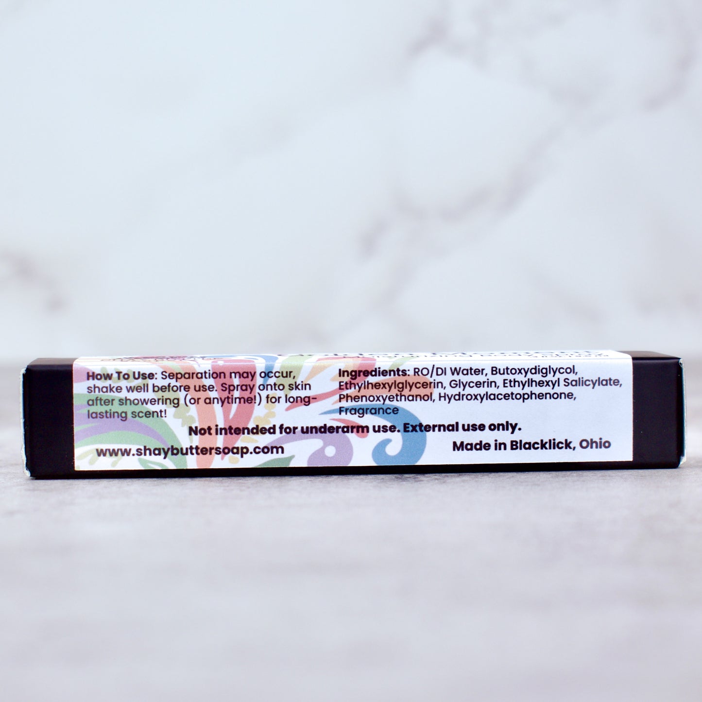 Body spray box with a label on a white background