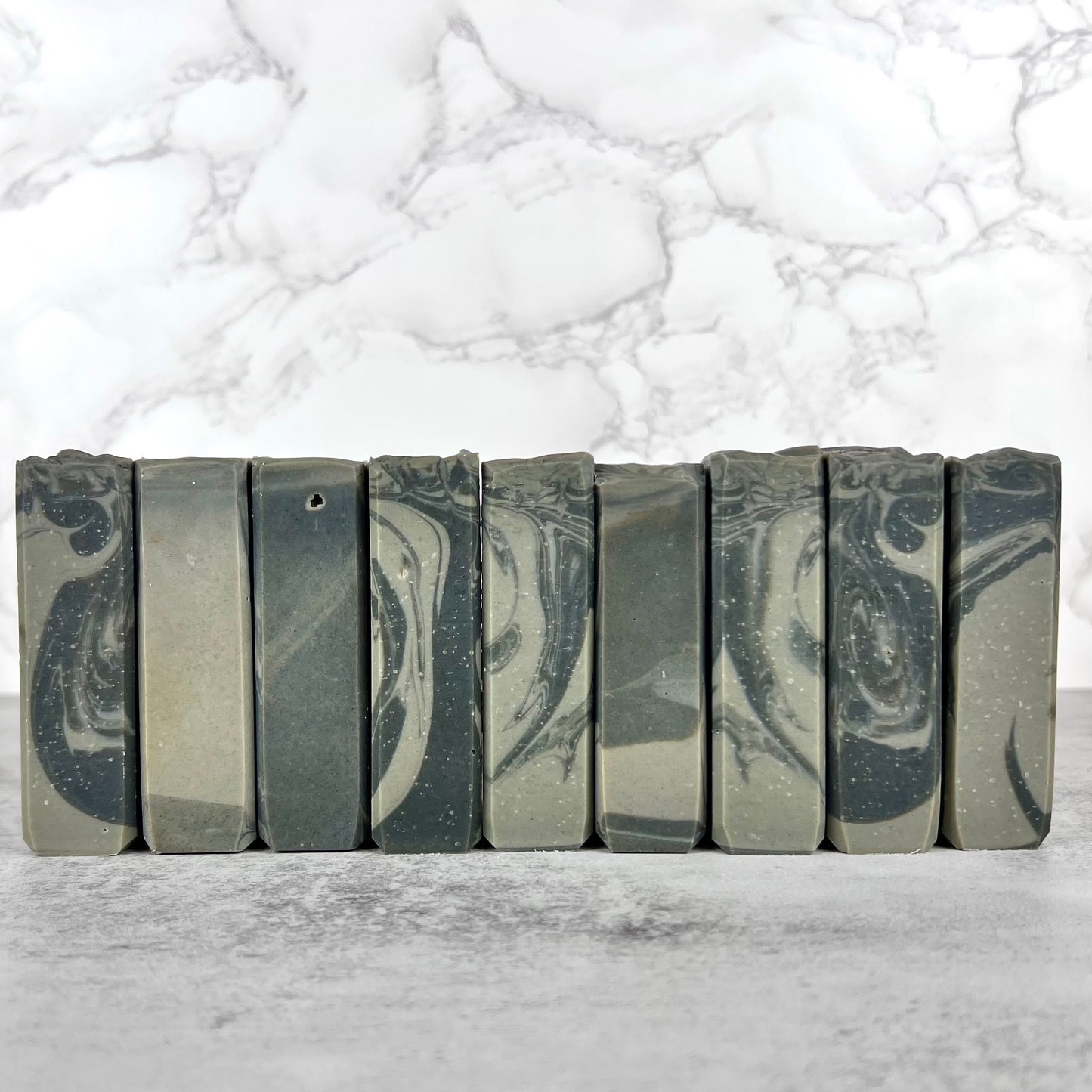 Marble-patterned soap bars on a marble surface