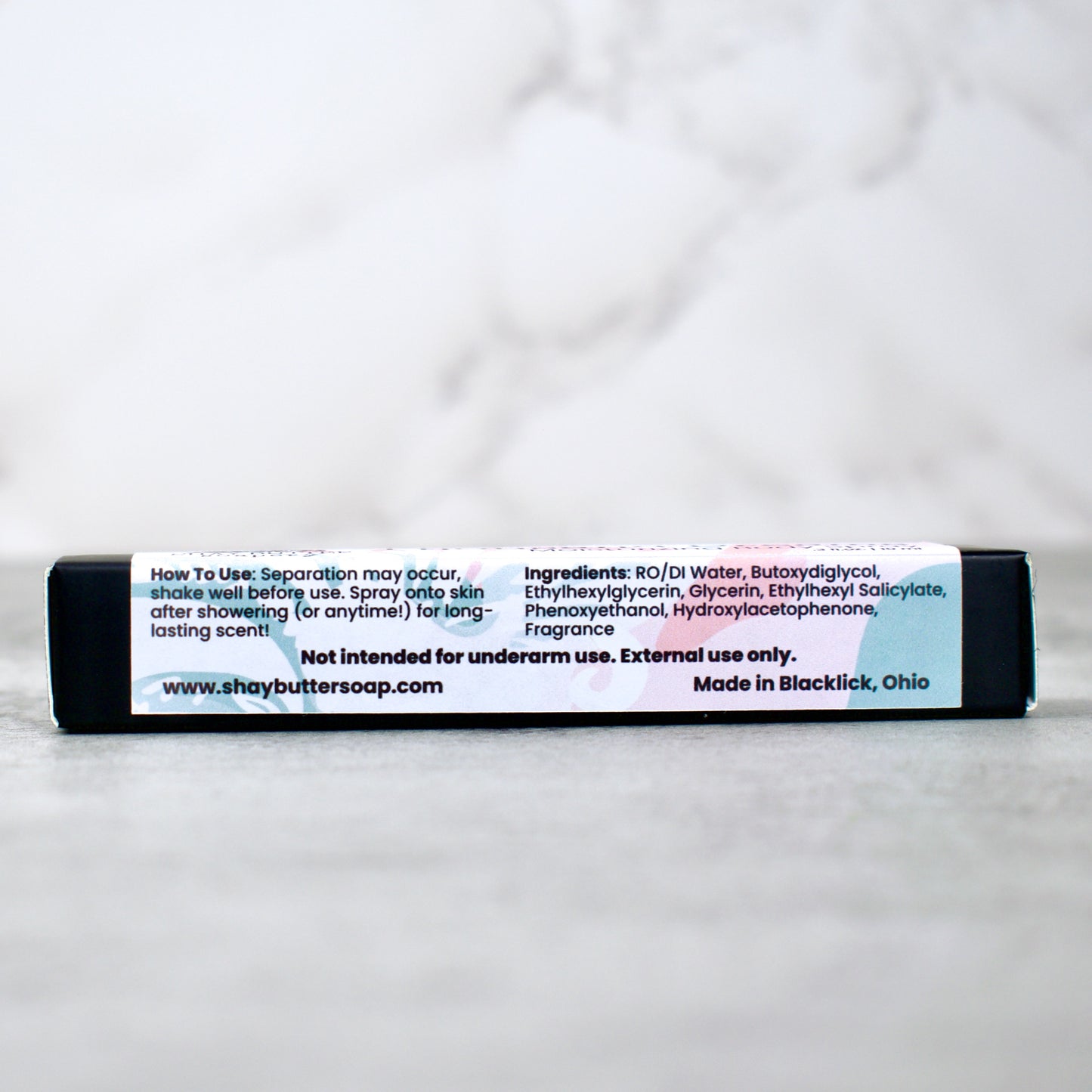 Body spray packaging with a label on a white background