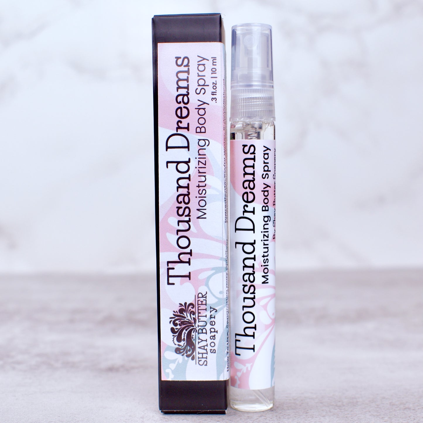 Thousand Dreams moisturizing body spray with packaging on a light gray background
