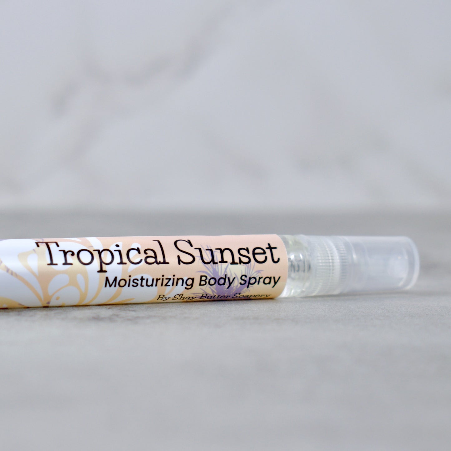Tropical Sunset moisturizing body spray on a light gray background
