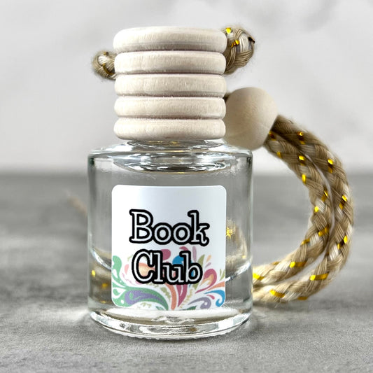 Car diffuser with a wooden top labeled 'Book Club' on a neutral background