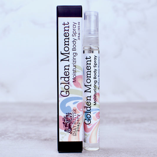 Golden Moment moisturizing body spray with packaging on a light gray background