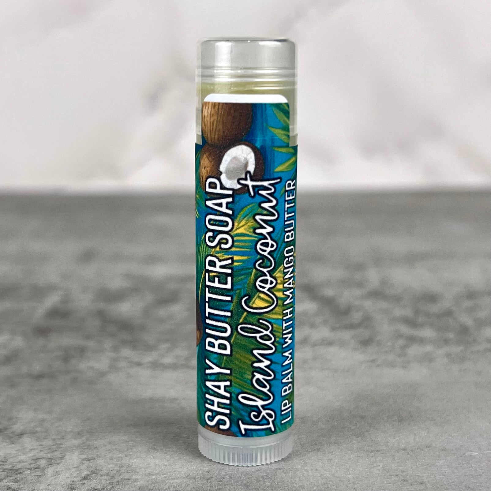 Lip balm with coconut flavor packaging on a gray background