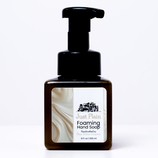 a bottle of "Just Plain" foaming hand soap on a white background