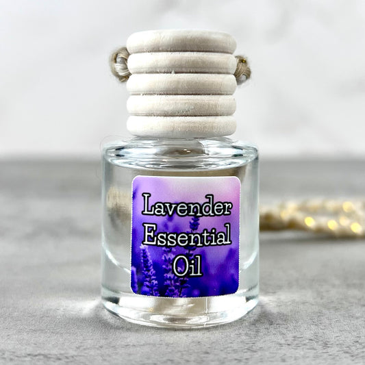Lavender essential oil car diffuser with purple label on grey surface.