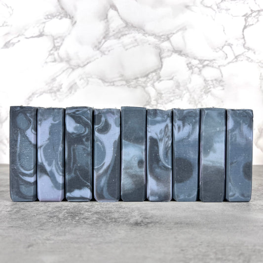 Marble-patterned soap bars on a gray surface with a marble background