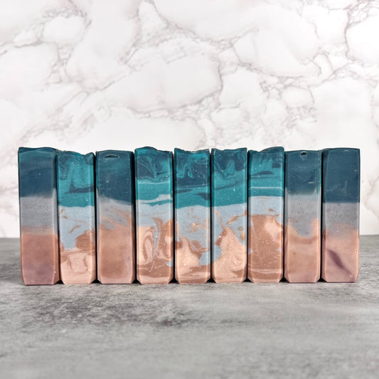 Row of coastal themed soap bars on a marble background