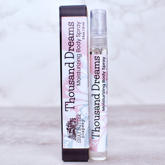 Thousand Dreams moisturizing body spray with packaging on a light gray background